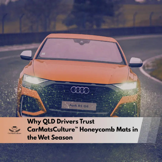 Orange Audi driving on a wet road with rain splashing during Queensland’s wet season