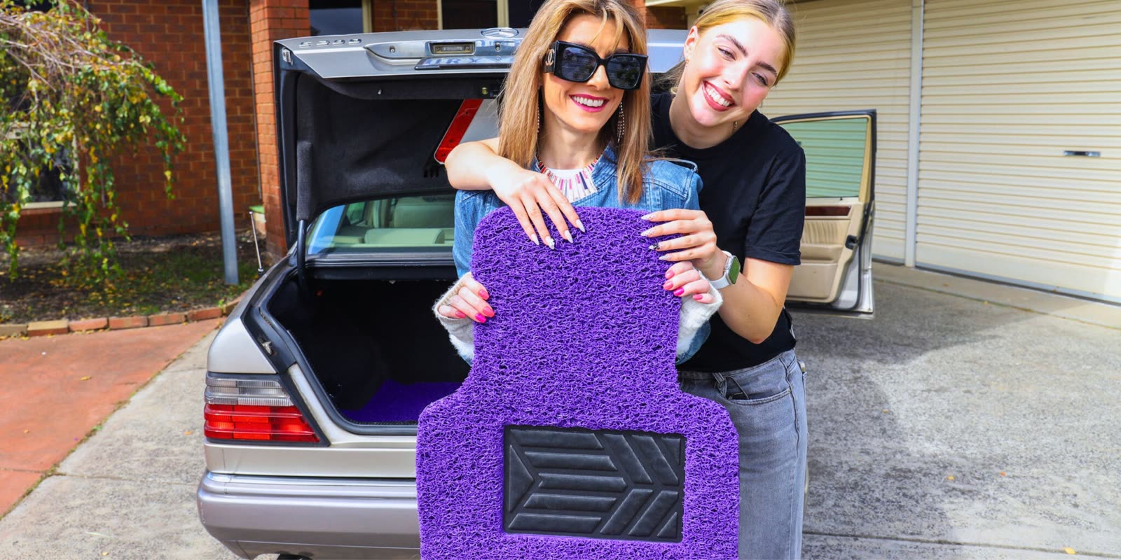 Two people celebrating with a colourful custom-fit Car Mats Culture car mat