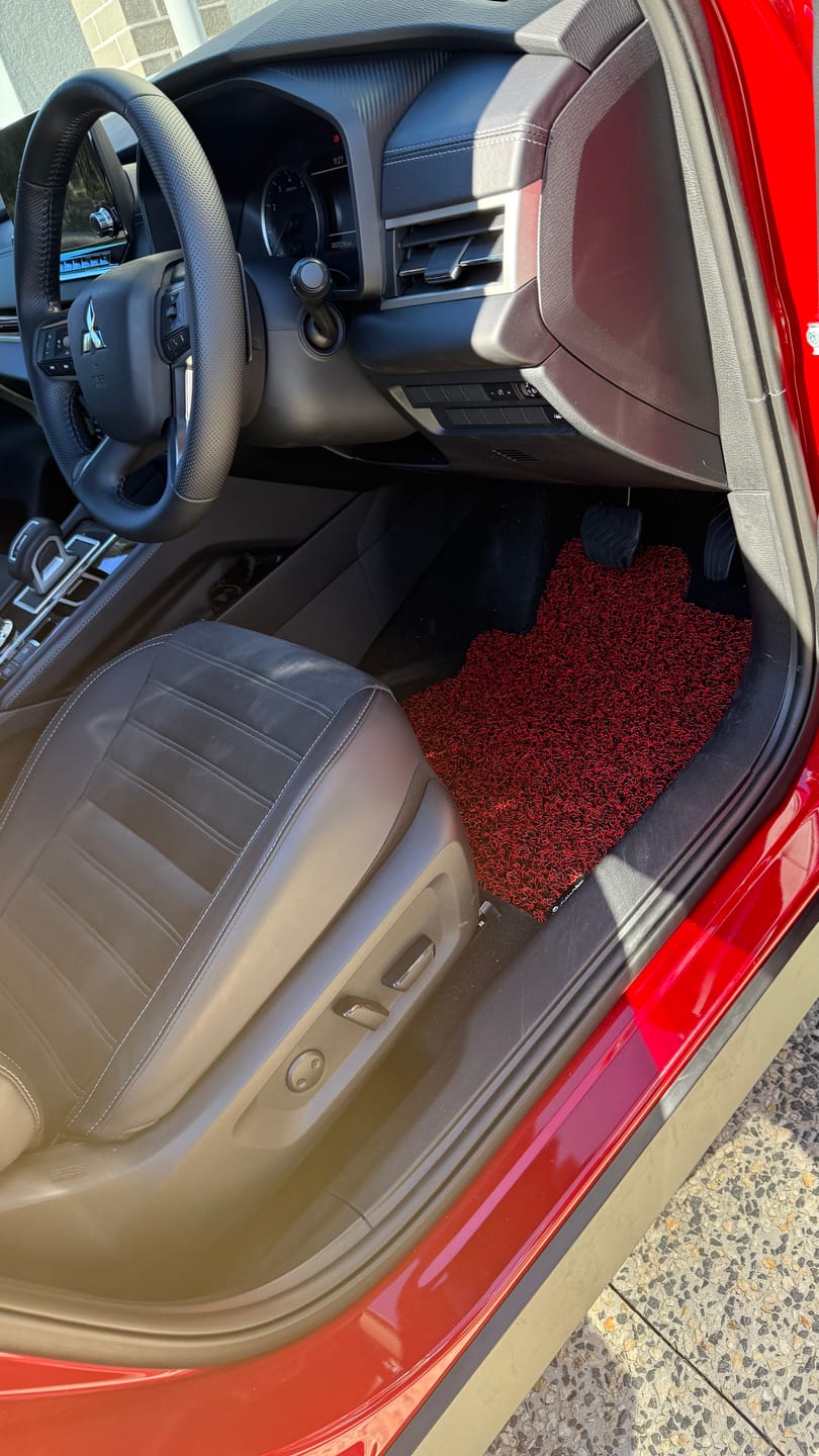 Vivid Burgundy honeycomb driver mat fitted in Violet W.'s vehicle