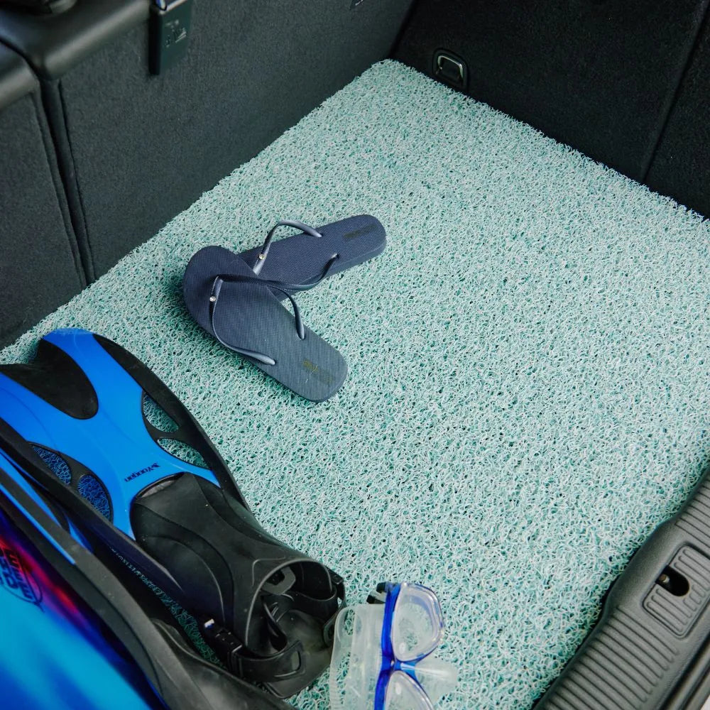 Customer cleaning an Aqua CarMatsCulture mat after everyday use